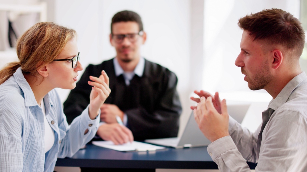 couple arguing in front of lawyer