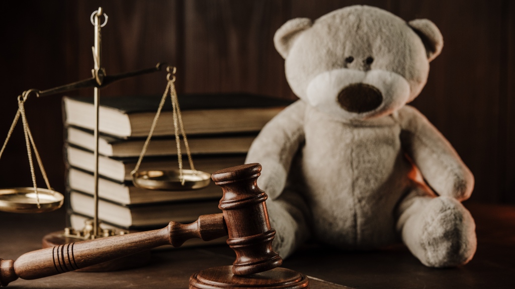 Wooden gavel and teddy bear
