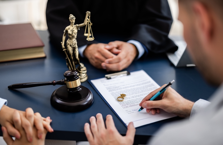 couple consulting with a lawyer in court to sign a divorce agreement document