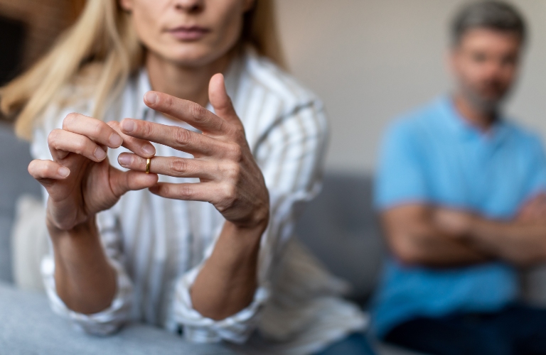 lady takes off ring, ignoring man during quarrel in living room