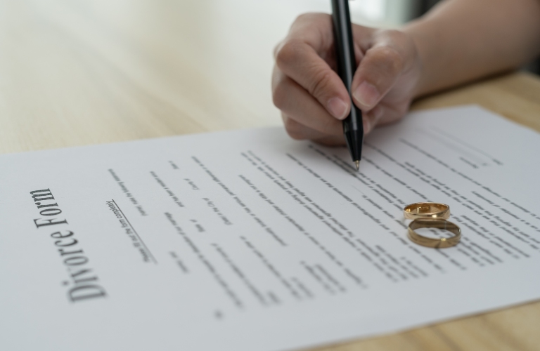 woman filling out divorce forms