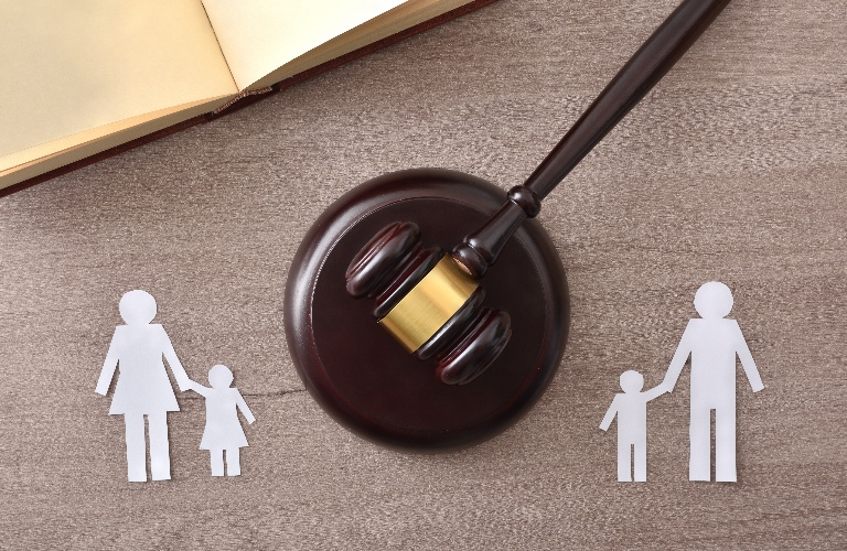 paper family figures divided by judge's gavel