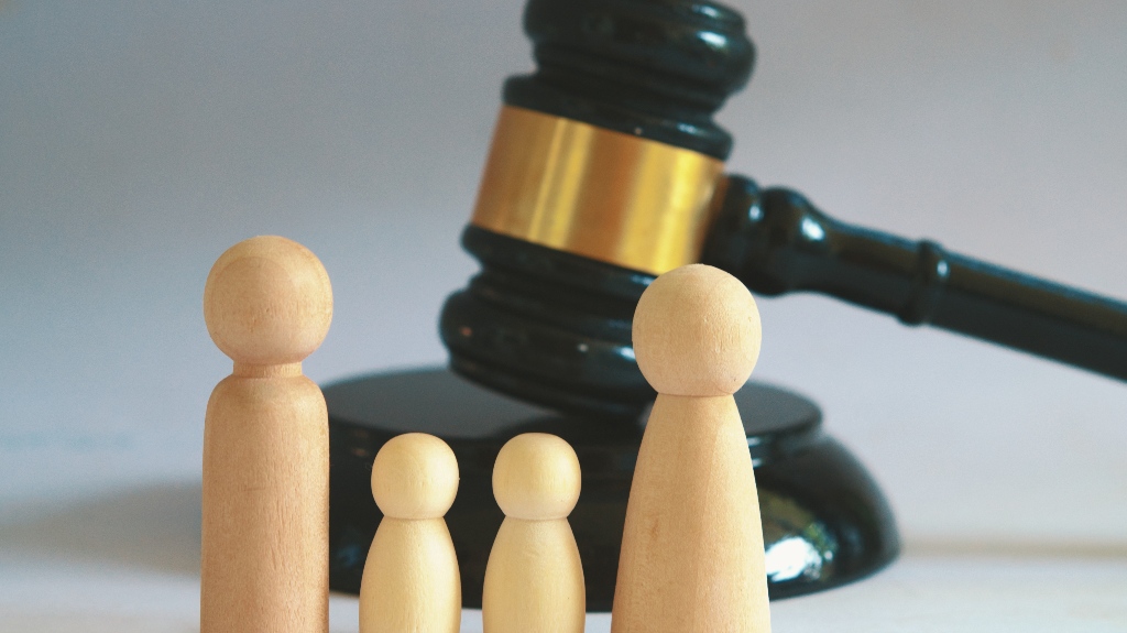 wooden family figures and judge's gavel