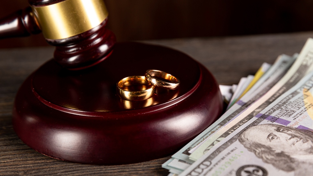 Judge's gavel, wedding ring and money