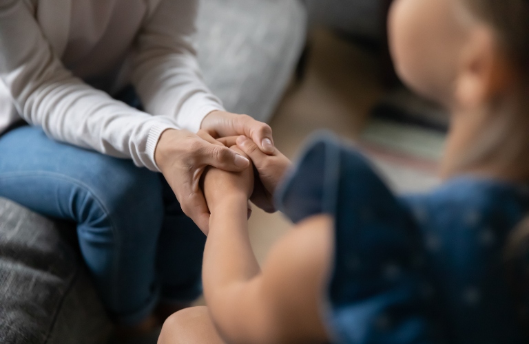 loving young mother hold small teen daughter hands