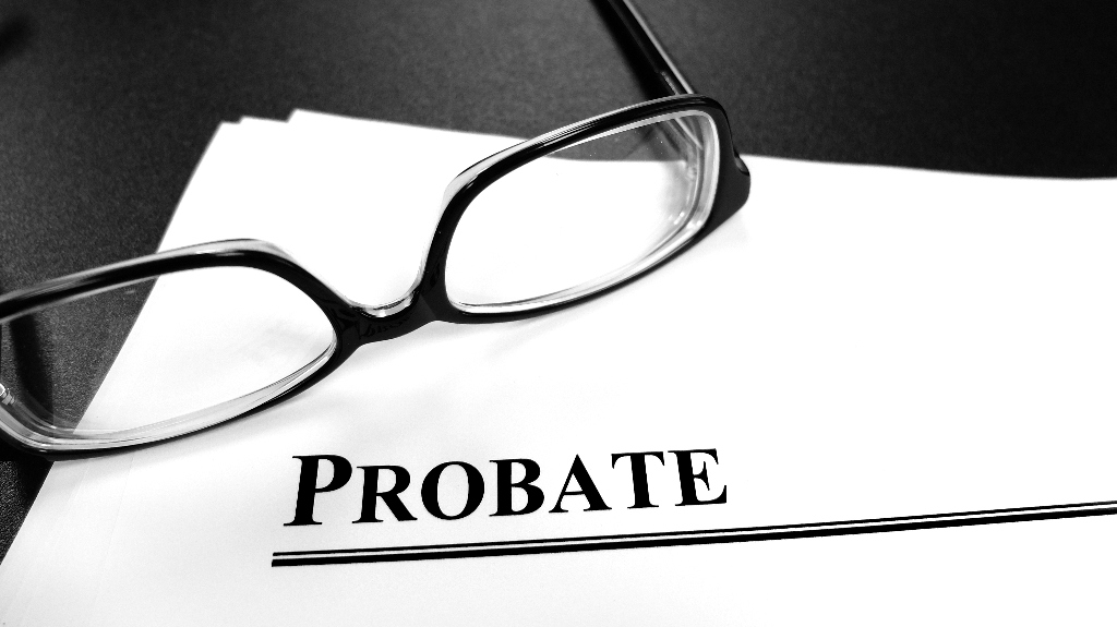 probate documents on desk with glasses