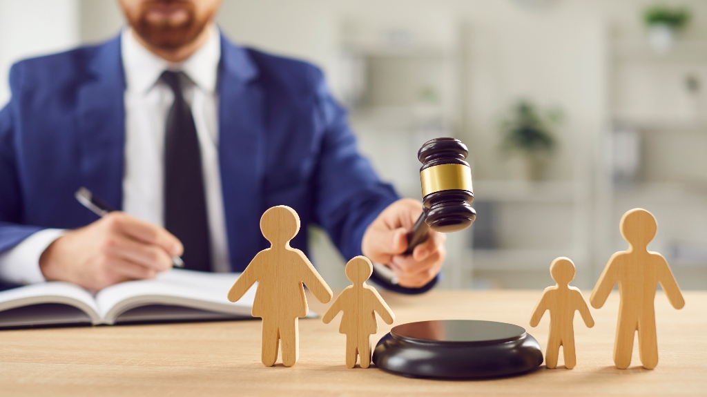 wooden figure of family and lawyer is holding judge's gavel