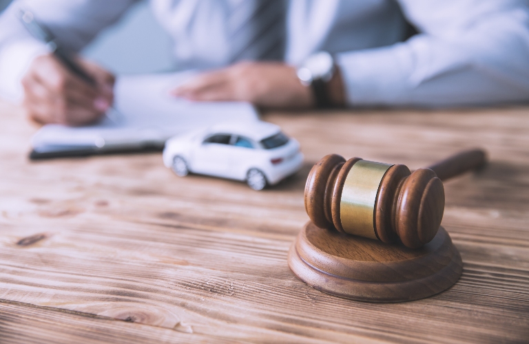 Lawyer with car model and documents