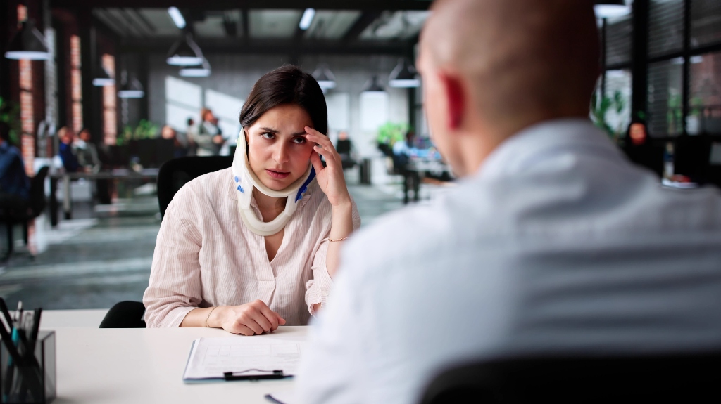 Woman with personal injury is consulting with lawyer