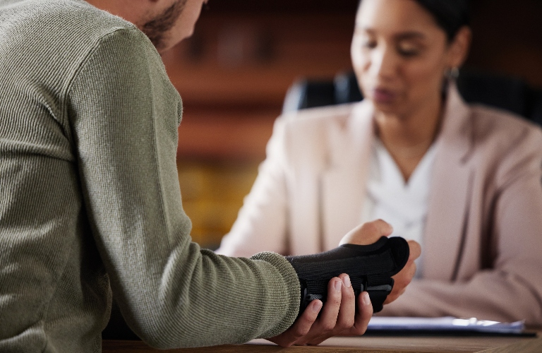 man with hand injury is consulting with lawyer