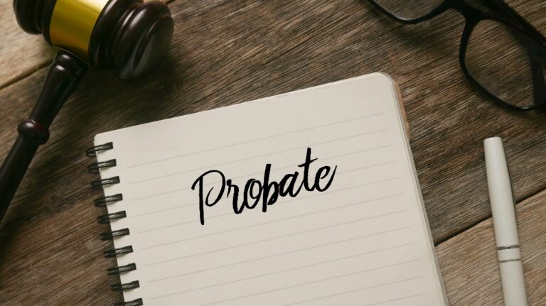 Gavel, glasses, pen and notebook with word Probate_s