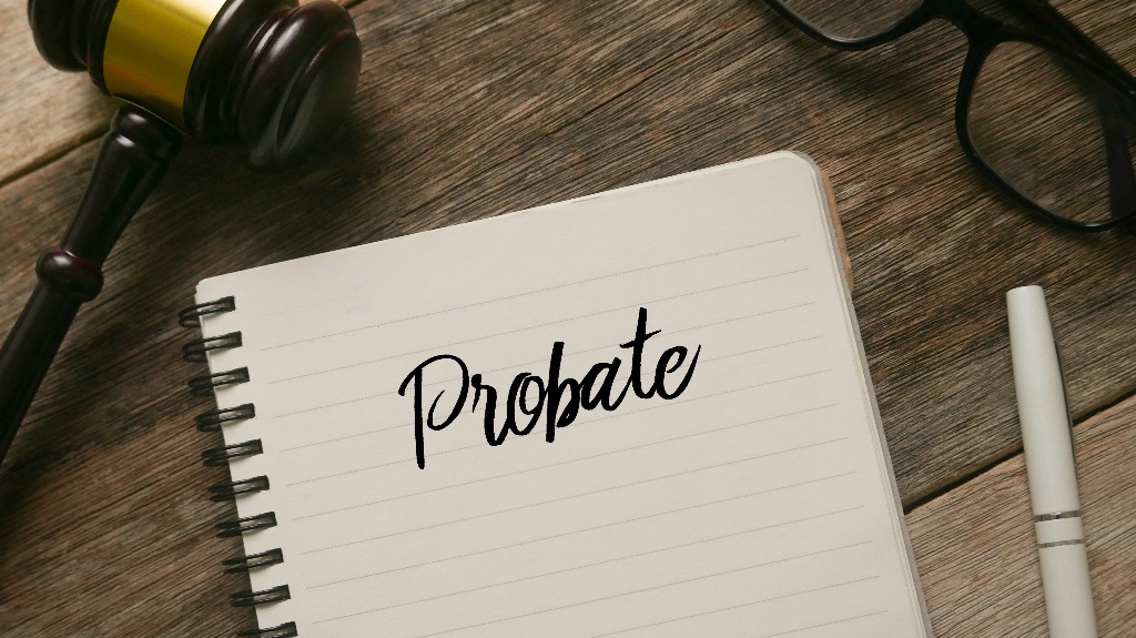 Gavel, glasses, pen and notebook with word Probate_s