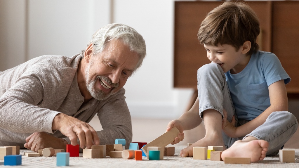 Grandfather is playing with little boy