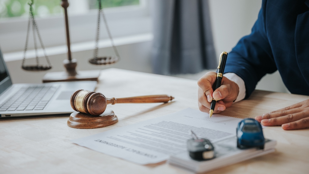 Lawyer with car model and documents