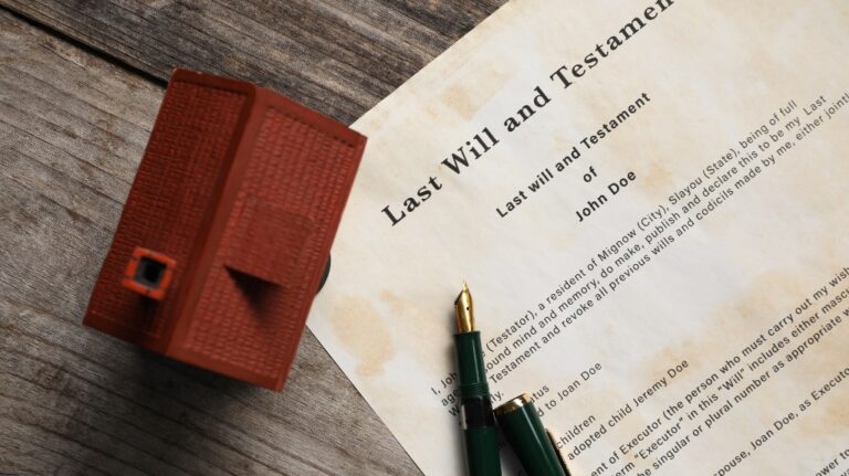 Last Will and Testament with fountain pen and house model