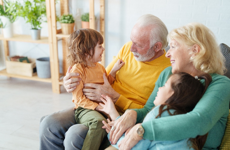 grandparents holding their two grandchildren
