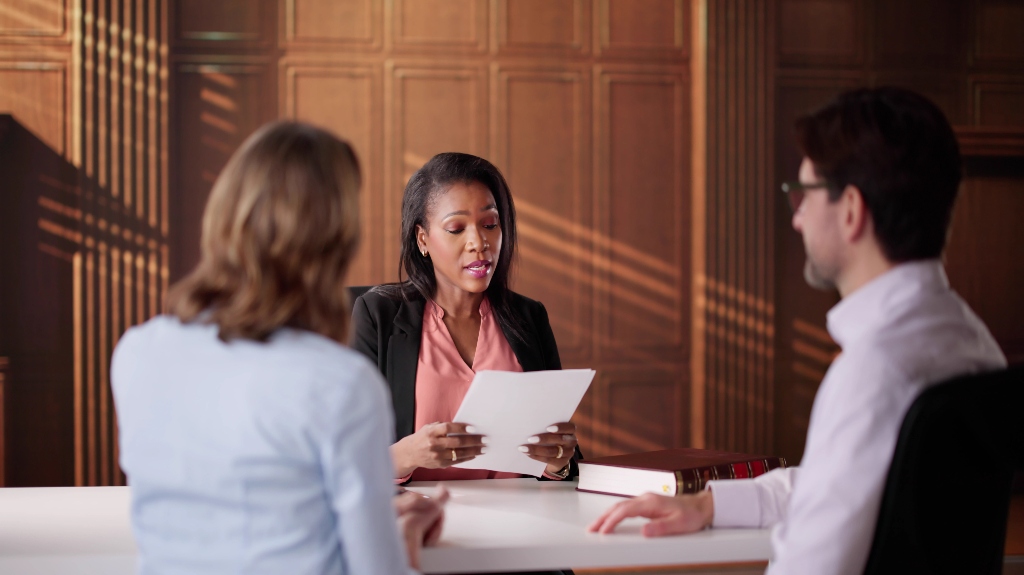 lawyer discussing paperwork with couple