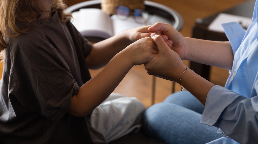 Adult and children's hands together